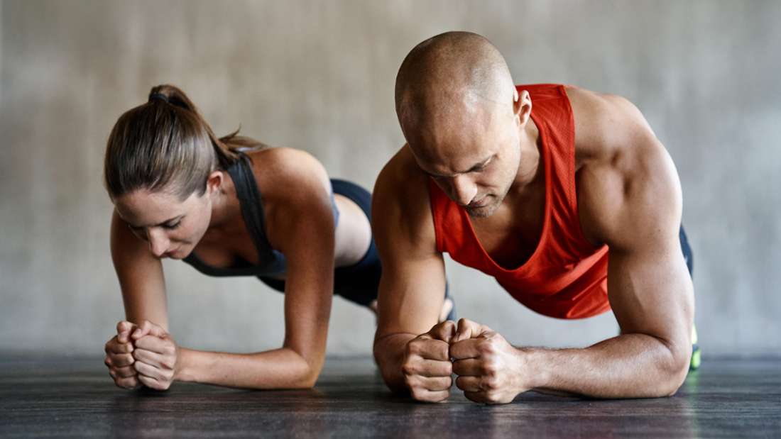 Fit couple doing planks