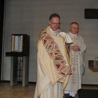 Pastor Johannes Hammer (front) and hospital chaplain Christoph Lange celebrated the last mass in the packed church.  Here Pastor Hammer carries the Blessed Sacrament out of the chapel.